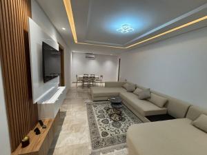 a living room with a couch and a flat screen tv at Le Relais Résistance Luxury in Sousse