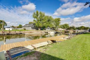 a dock on a river with boats in the water at Walk to Lagoon Saloon! Chic Home on Nugents Canal in Lacarne