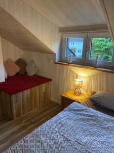 a bedroom with a bed and a window at Ferienhaus an der Kaiserpfalz in Niederdorla