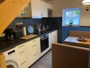 a kitchen with a sink and a stove top oven at Ferienhaus an der Kaiserpfalz in Niederdorla