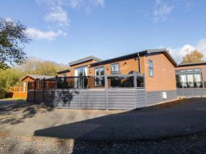 ein großes Haus mit einem Zaun davor in der Unterkunft 7 Lake View in Troutbeck Bridge