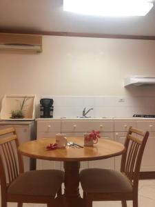 a kitchen with a table and chairs with bows on it at Fond Bay Suites Hotel - Breathtaking Ocean Views in Micoud