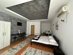 a living room with a bed and a table at Vila Madera Priboj in Čitluk +14 photos