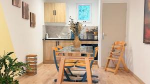 ein Esszimmer mit Tisch und Stühlen in einer Küche in der Unterkunft Appartement familial 4 personnes avec piscine & parking in Arles
