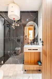 a bathroom with a sink and a mirror at Cosy Maarif Arena by Viva Stay in Maarif