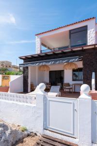 a house on the beach with a white fence at Sand & Beach in Pájara