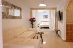 a living room with a couch and a bedroom at Sand & Beach in Pájara