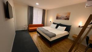 a hotel room with a bed and a couch at Eda7 Boutique Rooms in Sarajevo