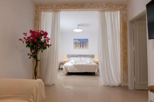 a bedroom with a bed and a vase of flowers at Sand & Beach in Pájara