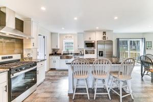 a kitchen with white cabinets and a table and chairs at 8 Mi to Jiminy Peak Resort Mtn-View Home with Deck in Stephentown