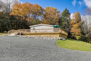 a house on a gravel road in front of a house at 8 Mi to Jiminy Peak Resort Mtn-View Home with Deck in Stephentown