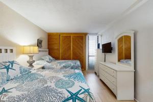 a bedroom with two beds and a dresser with a mirror at Pyramid 8K in Ocean City +10 photos