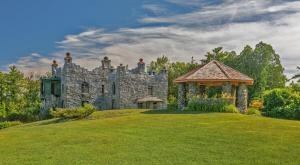 an old stone castle with a gazebo in a yard at Kimball Castle Legacy - Lake Views - Near Gunstock in Gilford