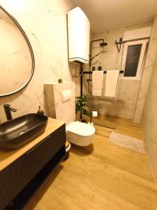 a bathroom with a sink and a toilet at DiViNI apartment in Zadar +12 photos