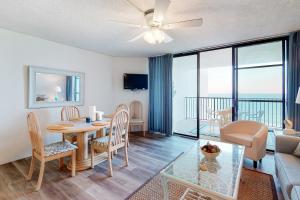a living room with a table and chairs and a dining room at Pyramid 9G in Ocean City