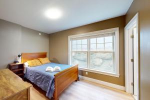 a bedroom with a bed and a window at Summer Cape Escape in Dennis Port