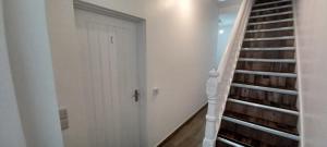 a stairway with a white door next to a white house at Brand New 1 Bed Apartment - 3 Guests in Parkside