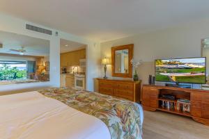 une chambre avec un lit et une télévision à écran plat dans l'établissement Maui Eldorado Resort A208, à Kaanapali