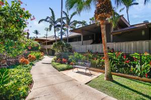 a walkway in front of a house with a bench at Maui Eldorado Resort E205 in Kaanapali