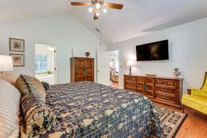 a bedroom with a bed and a flat screen tv at 2 Mi to KSU Family Home with Games, Near Parks in Kennesaw