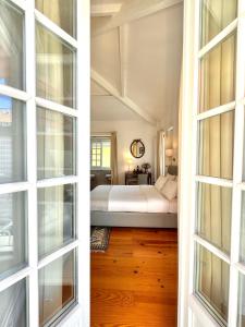 two views of a bedroom with a bed through a window at Casa das Laranjas in Porto