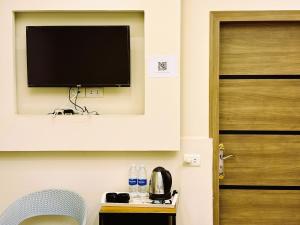 a flat screen tv on a wall next to a door at The View Pyramids Gold one in Cairo