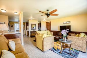 a living room with couches and a ceiling fan at Pono Kai Resort D101 in Waipouli