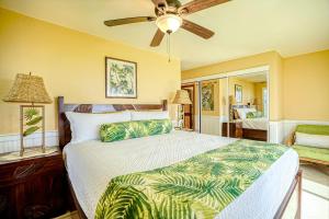 a bedroom with a bed and a ceiling fan at Pono Kai Resort D101 in Waipouli +36 photos