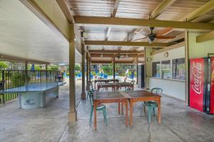 a patio with a ping pong table and chairs at Pono Kai Resort D101 in Waipouli