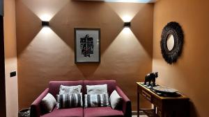 a living room with a purple couch and lights at Jacaranda stylish ambiance with volcano and ocean views in Tacoronte +26 photos