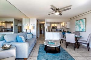 a living room with a couch and a table at Papakea Resort E203 in Honokowai