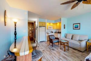 a living room with a couch and a table at Papakea Resort C204 in Honokowai