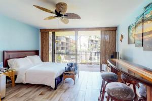 a bedroom with a bed and a balcony at Papakea Resort C204 in Honokowai +41 photos
