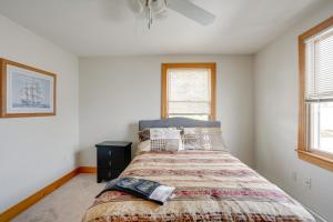 Steps to Nantasket Beach Waterfront Gem with Patio! في Nantasket Beach: غرفة نوم بها سرير ونافذتين