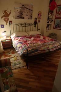 a bedroom with a bed with a quilt on it at All'ingresso delle antiche mura della città in San Marino