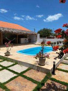 a villa with a swimming pool and a house at Brisa Mansa in Barra Grande