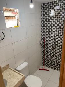 a bathroom with a toilet and a shower at Brisa Mansa in Barra Grande