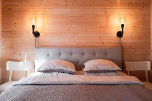 a bedroom with a large bed with two pillows at Kanali Guest House - Sauna Included - Free Parking in Pärnu +17 photos