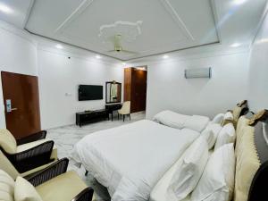 a hotel room with a bed and a television at Best Eastern Hotel Multan in Multan +30 photos