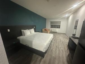 a bedroom with a large white bed in a room at Studio 6 Extended Stay Houston, TX - Westchase in Houston