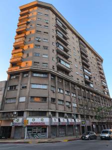 a tall building with cars parked in front of it at Libertador 6 MVD in Montevideo +11 photos