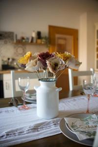 a vase filled with flowers sitting on a table at Ferienwohnung Peters (EG) in Hünfeld