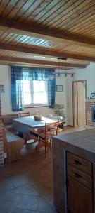 a living room with a table and a couch and a table at Dovolenkový dom na juhu Slovenska in Jahodná