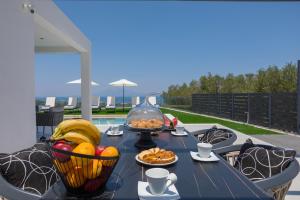 a table with bowls of fruit on a patio at Villa Marco in Zakynthos Town