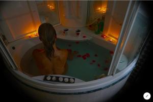 a woman in a bath tub with at All'ingresso delle antiche mura della città in San Marino