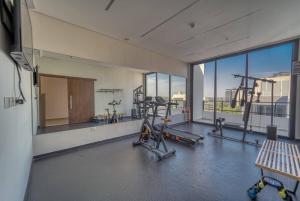 a gym with two treadmills and a large window at Firenze 5G - Vivelite in Caña de Castilla