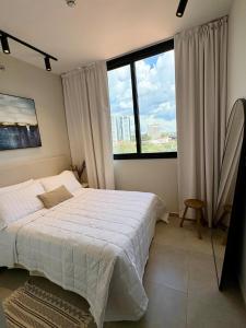 a bedroom with a bed and a large window at Firenze 5G - Vivelite in Caña de Castilla +13 photos