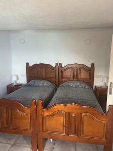 a large wooden bed in a room with two tables at Casa lucas in Almáciga