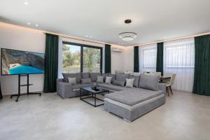 a living room with a couch and a tv at Villa Marco in Zakynthos Town