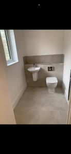 a bathroom with a toilet and a sink at Brand new house oxford in Oxford
